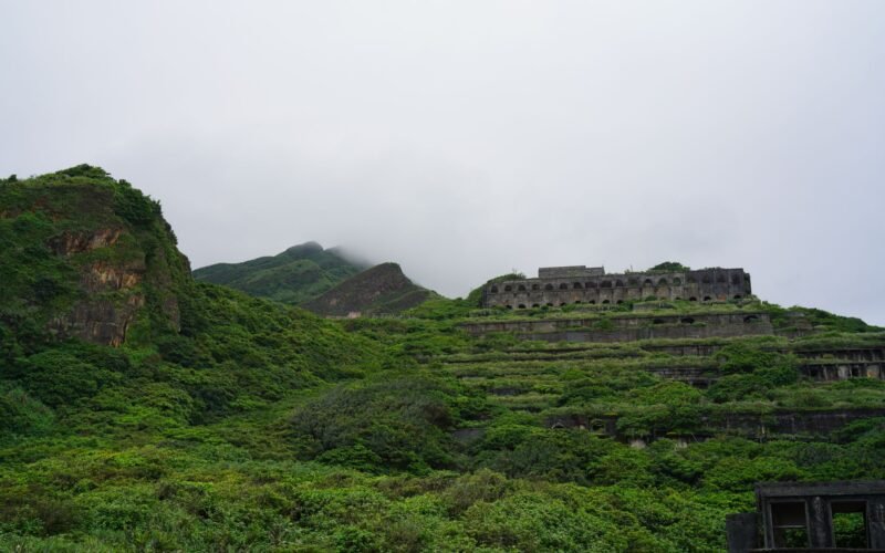Abandoned ruins in misty green hills, a scenic view perfect for exploration.