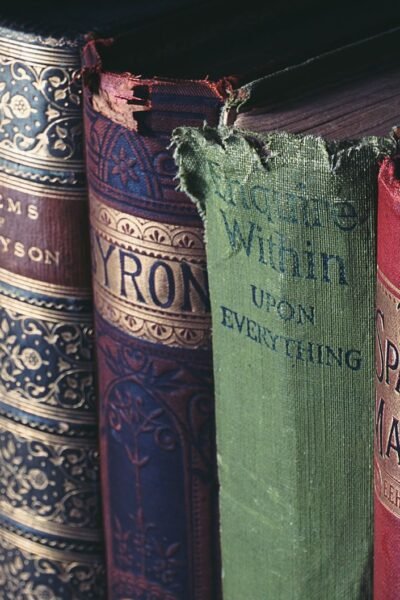 Close-up of vintage hardcover books showcasing ornate book jackets and titles.