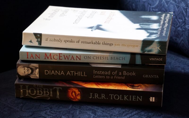 A stack of classic novels including works by McEwan, Athill, McGregor, and Tolkien.