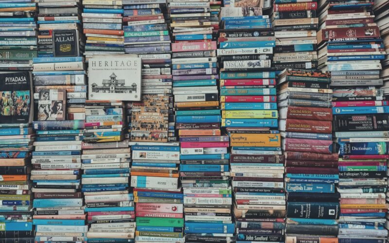 A vibrant collection of stacked books creating a visually arresting pattern in a Dhaka bookstore.