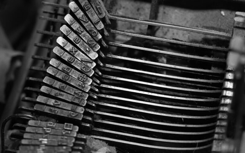 Detailed close-up of type hammers in a vintage typewriter, showcasing mechanical intricacy.